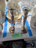 Front view of both sterling candlestick holders