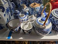 Group shot of blue and white ceramics including teapot, jars, bowls and vases