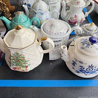 Group shot showing all five teapots with varied shapes and patterns