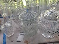 Group shot of all clear glass vases and decanter on table