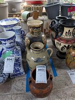 Group shot of the four vases within blue tape