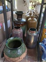Group shot of all six ceramic vases on floor