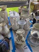 Overview of assorted white porcelain and milk glass vases, covered casserole, trinket box, music box, glass pitcher and ornament