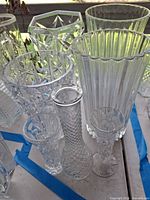 Group shot of all seven clear glass vases on table
