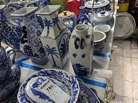 Group view of three blue and white vases on table