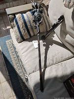 Walking stick full length with statue beside