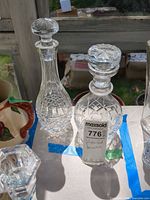 Both decanters side by side showing overall forms and stoppers