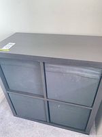 Front view showing four compartments with fabric bins installed