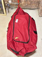 Red zippered storage bag housing tree sections
