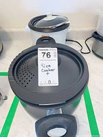 Front view of Bialetti black nonstick pot with tag on perforated lid and long handle