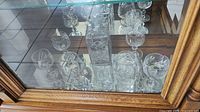 Front view showing decanter and surrounding glasses inside cabinet