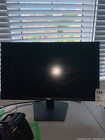 Front view of Dell SE2422H monitor on stand, screen off