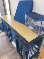 Full view of bench dog crate with cushion, wedge cushion and storage bag on top