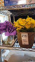 Both flower arrangements on shelf