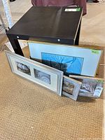 Group shot of all three framed prints leaning against table