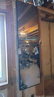 Front view of full-length mirror mounted vertically