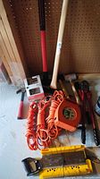 Overview of lot showing sledges, hammers, cord reel, bolt cutters, miter box, hardware box
