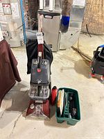 Full view of Hoover carpet cleaner with attachments in caddy