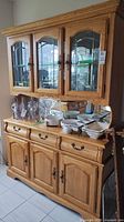 Full view of hutch showing upper glass display and lower storage
