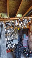 Multiple metal clip hangers and glimpse of grey patterned rug