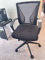 Full chair front view showing mesh back, seat, armrests and base