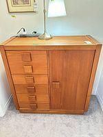 Front view of dresser showing five drawers and cabinet door