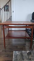 Front view of square teak veneer end table showing two tiers