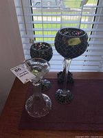 Group view showing three glass candle holders and bronze holder
