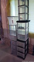 Front view of two tall drawer towers with bins on top