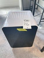 Front view of mini fridge with size tag visible