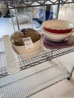 Entire lot on shelving: casserole with lid, egg tray, stacked bowls and platter