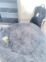 Top view of round grey shaggy faux fur dog bed