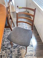 Front view of chair showing ladder back design and upholstery