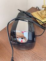 Top view of black Staples electric pencil sharpener with cord.