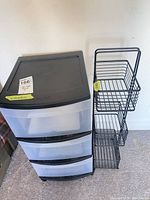 Front view of plastic drawer unit beside wire basket rack
