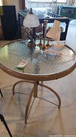 Round glass top metal patio table