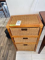 Front view of chest showing three wicker drawers