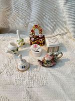 Group shot of all seven miniature porcelain and enamel items