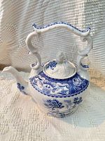 Full side view of teapot showing body, spout, handle and pattern