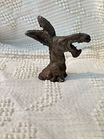 Front angled view of cast iron animal head figurine