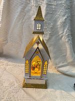 Front view of church snow globe showing full structure and lighting