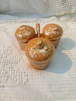 Front view of salt and pepper shakers with mustard jar in caddy