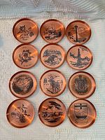 All 12 coasters laid out in four-by-three grid showing full set and varied motifs