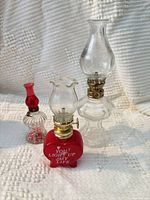 Three miniature glass oil lamps grouped together