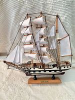 Full view of Simon Bolivar model ship on stand showing hull, sails, and rigging