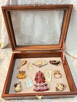 Open wood box showing all included miniatures