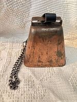 Front view showing copper patina, leather strap and chain