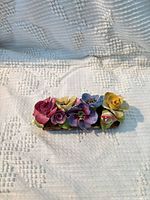 top view of porcelain floral centerpiece showing multicolour flowers on log base