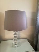 Full view of lamp with shade on tabletop