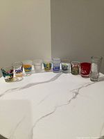 Row of all ten souvenir shot glasses